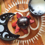 garnet sphere on wooden board